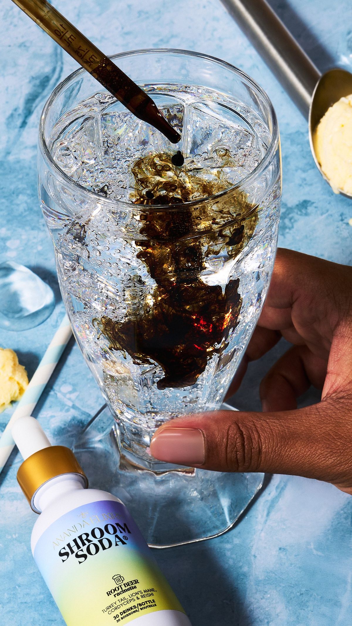 Shroom Soda being dropped into a glass of sparkling water