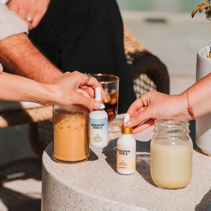 Friends mixing drinks with Shroom Soda®