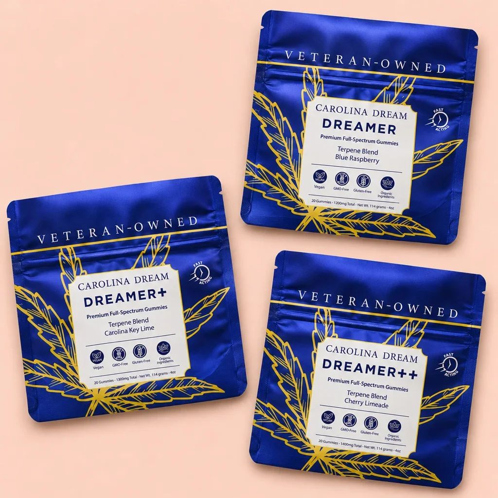 Three blue pouches of Carolina Dream Dreamer gummies are arranged on a peach background.