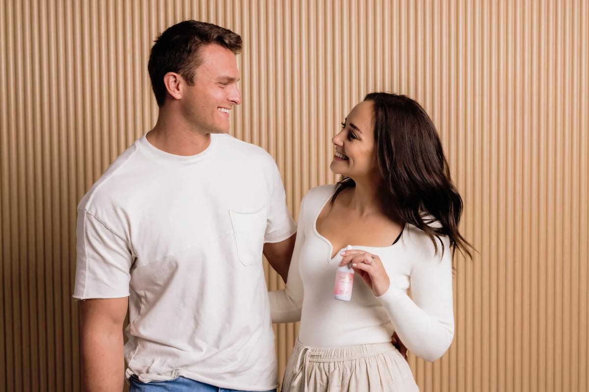 Dylan and Sammi Dreiling smiling at each other, Sammi holding a drink