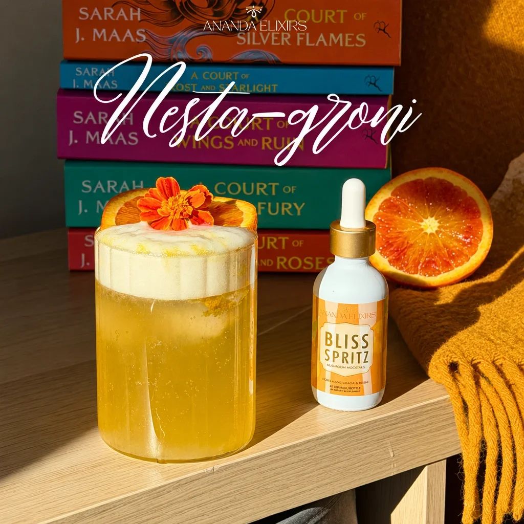 A cocktail with a foamy top, an orange slice, and a flower garnish.